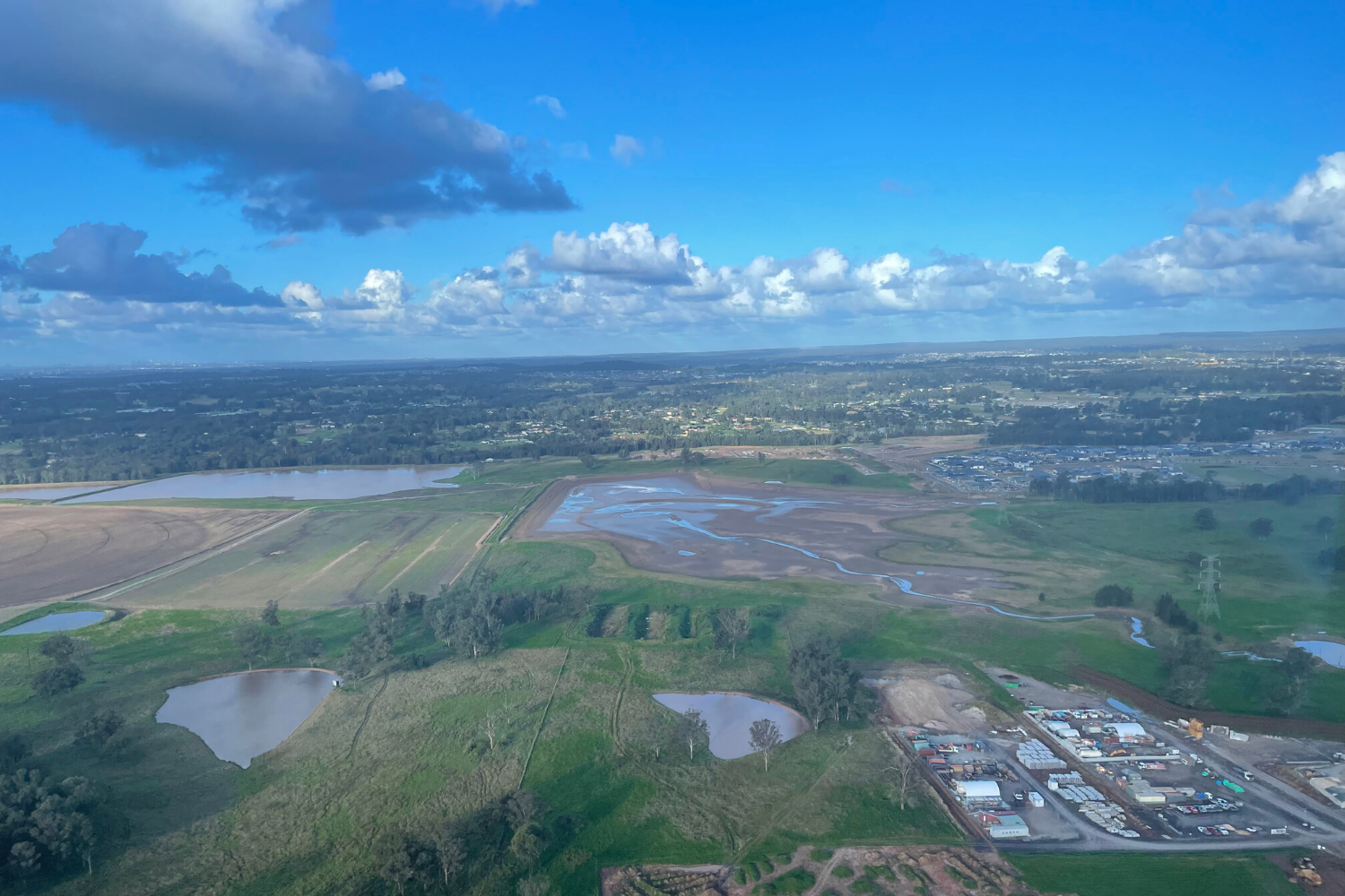 Aerial view of large dam on Oran Park property