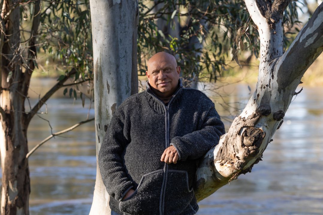 Phil Duncan stands in front of a tree with the Macquarie River in the background